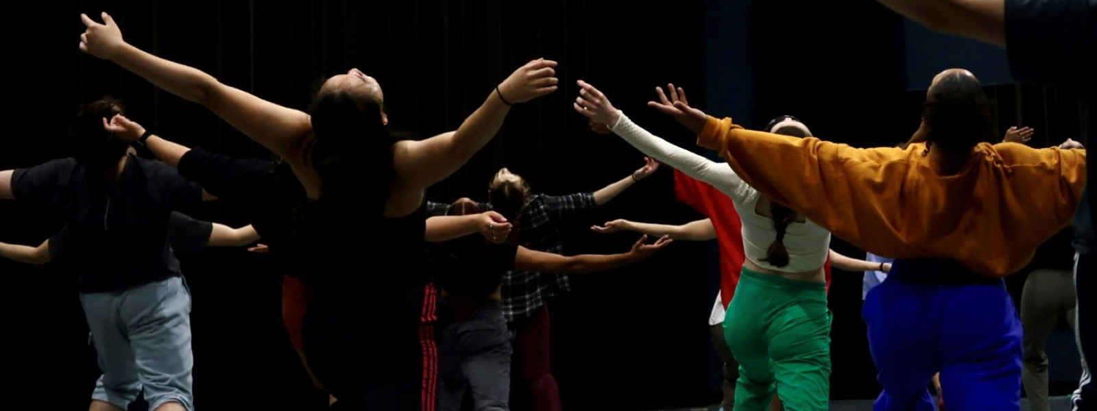 Dancers with their hands up while they're in the middle of a performance