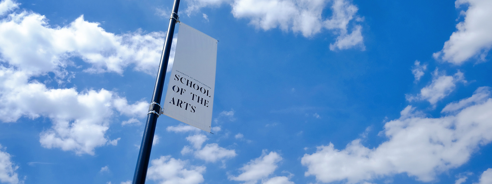 A pole facing the sky with a banner.