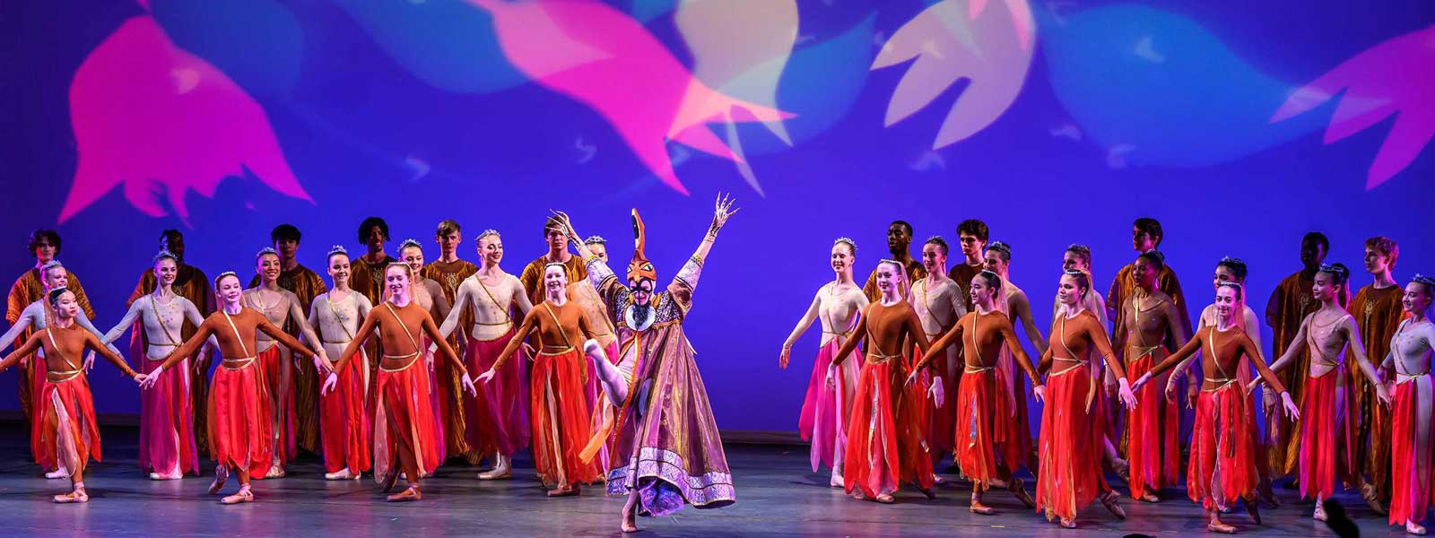 Dancers on stage performing in costume